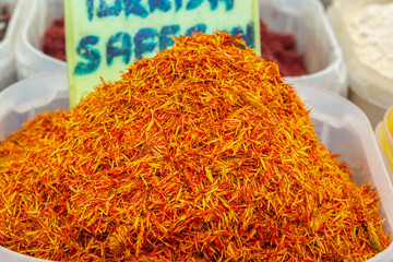 Dry red saffron is sold at a street bazaar. Close-up