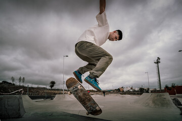 young skater jumps a ramp with his skateboard