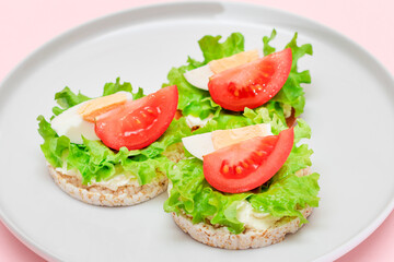 Rice Cake Sandwiches with Tomato, Lettuce and Egg on White Plate. Easy Breakfast. Diet Food. Quick and Healthy Sandwiches. Crispbread with Tasty Filling. Healthy Dietary Snack