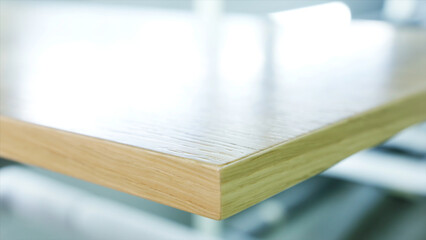 Close-up of large polished wooden board lying on the table at the wooden workshop or factory. Action. Production, manufacture and woodworking industry concept