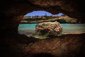cave in the paradisiacal sea with natural eye form, Cala Domingos, mallorca, spain
