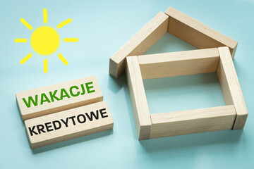 Wakacje Kredytowe text in Polish denoting credit holidays, State program to help borrowers in Poland repay loans during the crisis, Creative concept, Home and written with blocks - obrazy, fototapety, plakaty
