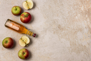 Apple Cider Drink or Fermented Fruit Drink and Organic Apples on Concrete Background Healthy Eating and Lifestyle Concept Harvest Copy Space