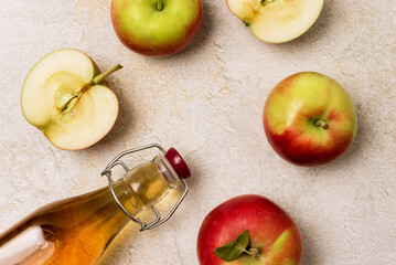 Bottle of Apple Cider on Concrete Background Raw Apples Apple Vinegard or Apple Juice Top View