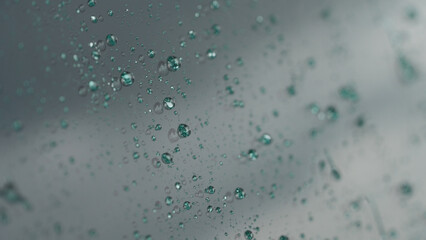 rain drops beading on hydrophobic car glass