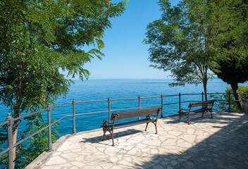 two benches at viewpoint, walkway along seaside adriatic coast, croatia