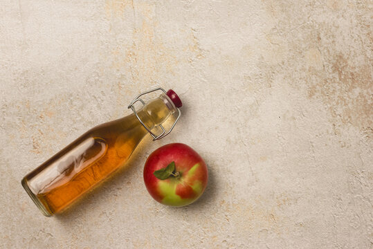 Bottle of Apple Cider on Concrete Background Raw Apples Apple Vinegard or Apple Juice Copy Space