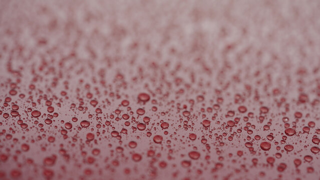 water beading on red car with hydrophobic coating