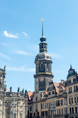Obraz premium Cityscape over historical and touristic center in Dresden downtown, old clock tower near Cathedral of Holy Trinity and theater square, Dresden, Germany, at summer sunny day and blue sky.