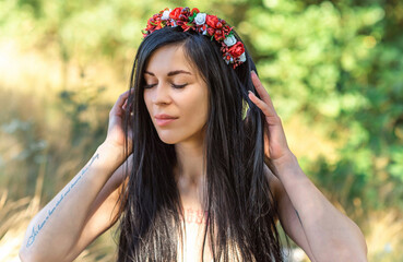  Woman in ethnic dress, flower wreath in hair. Concept of beauty European girl, Boho romantic style