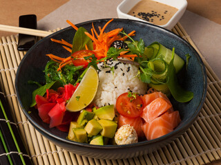 Hawaiian poke dish with salmon and avocado. close-up