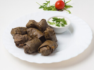 dolma - minced meat in grape leaf with kiferno-garlic sauce
