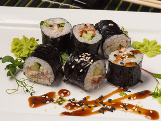 sushi maki rolls with cucumber and eel with unagi sauce