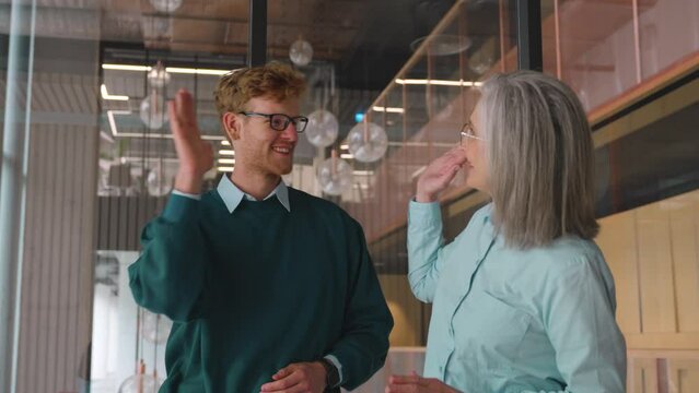 Happy And Excited Teacher And Student Giving High Five Standing In Office.