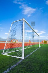 Fototapeta premium STADIUM - Football field with goal and tablo on blue sky