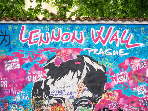 Prague, Czech Republic - June 2022: Close up detail with grafitti drawings on the Lennon Wall in Prague.