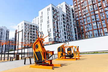 Street workout gym with stepper and fitness equipment outdoors in the residential apartment district