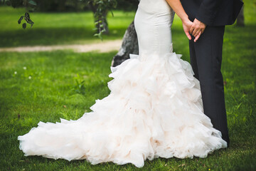 The bride and groom hold each other's hands