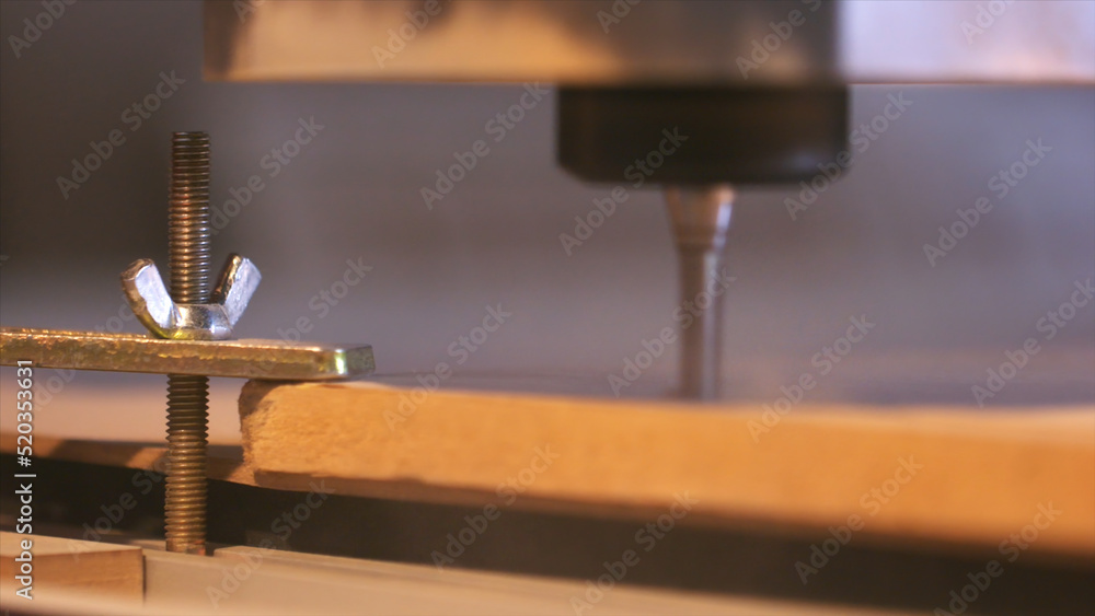 Poster close-up of wood cutting machine controlled by computer while he is carving wood. action. cnc millin