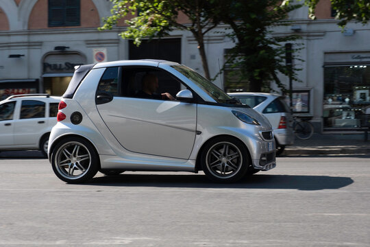 ROME, ITALY - JULY 16 2022: Smart car drives on an asphalt road in the center of Rome. Rome has the highest number of Smarts in Italy, thanks to their versatile parking options. Background motion blur