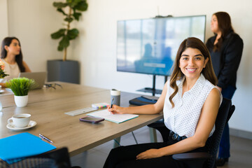 Beautiful female boss on a work meeting feeling happy