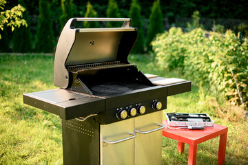 Beautiful close-up view on modern portable BBQ barbecue grill