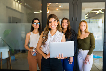Beautiful happy boss with her working team