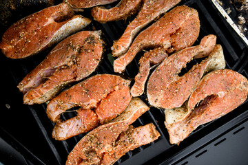 top view on raw salmon steaks on grill