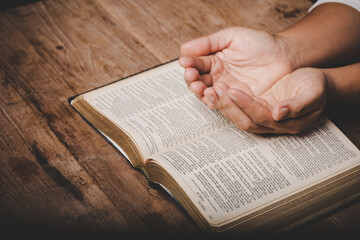Close up of christian woman hand on holy bible are pray and worship for thank god in church with...