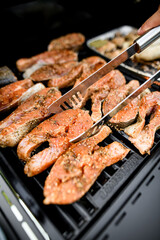 Close-up view of tasty salmon steaks fried on grill
