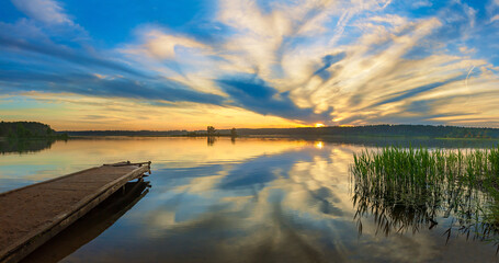 Beautiful panorama landscape with sunrise over the water lake