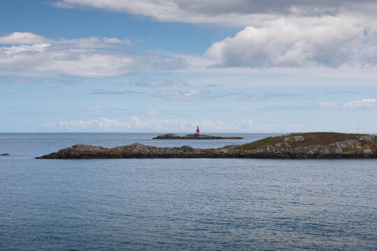 Seascape with Muglins Lighthouse in the calm Irish Sea. Photo taken on the coast in Dalkey, County Dublin, Ireland.