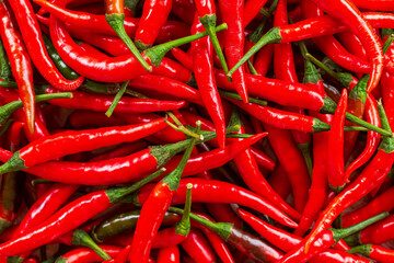 macro red chili,Red chili pepper background,Red hot chili peppers pattern Chili texture background. Close up landscape background of hot chili peppers. Roadside vegetable market. Red chili group.