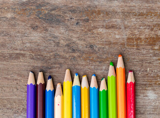 blunt coloured pencils on wood floor.