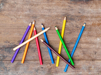 blunt coloured pencils on wood floor.