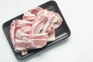 Raw fed bacon strips on white background 