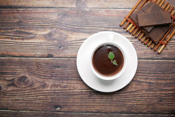 flat composition of dark chocolate cream in a coffee cup on table 