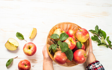 Apples. Fresh ripe red apples in the basket at white table. Top view.