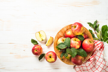 Apples. Fresh ripe red apples in the basket at white table. Top view.