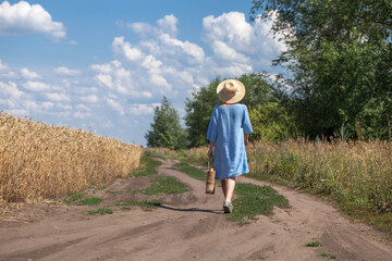 Village woman walking along a country road