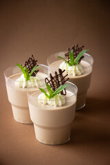 Chocolate mousse  -low calorie dessert on cups, whipped cream, mint leaves
