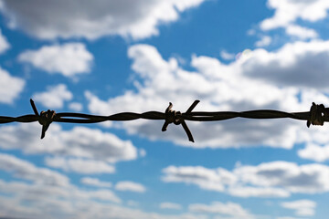 Barbed wire at daylight with blue sky freedom