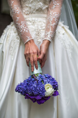 Bright wedding bouquet in hands of the bride