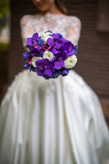 Bright wedding bouquet in hands of the bride