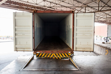 Empty heavy container truck parked or docked at warehouse loading area. Postal and logistic...
