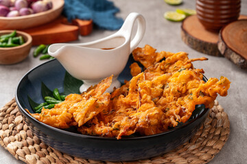 Bakwan is a vegetable fritter or gorengan from Indonesian cuisine.The ingredients are vegetables, usually beansprouts, shredded cabbages and carrots, battered and deep fried in cooking oil.