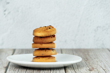 Chip Cookies in place  on wood table with concrete background