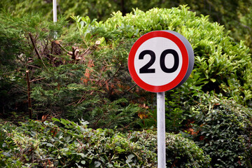 Road sign showing a 20 mph speed limit at the approach to a residential area - obrazy, fototapety, plakaty