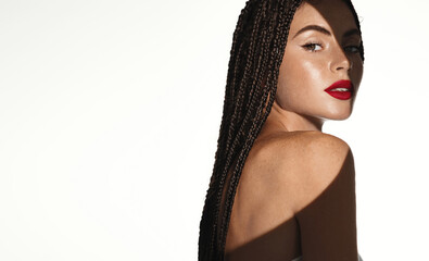 Women beauty and makeup. Woman with red lipstick on, looking behind her bare shoulder, wearing make...