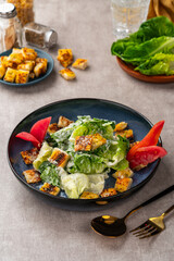 Caesar salad is a green salad of romaine lettuce and croutons dressed with mustard, Parmesan cheese, and garlic bread.